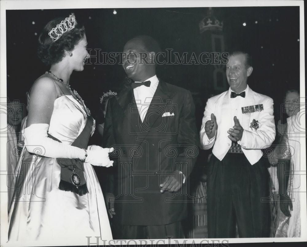 The Duke looks on laughing as Nkrumah asks the Queen to Dance